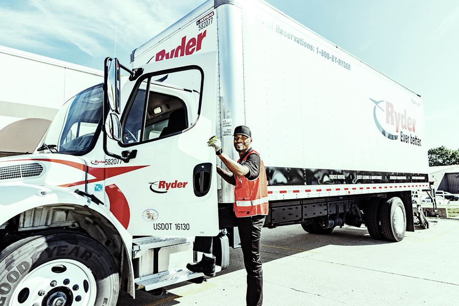 healthcare truck driver stepping into truck